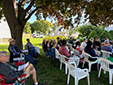 second view of congregation seated outdoors