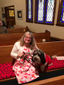 woman holding dog in pew